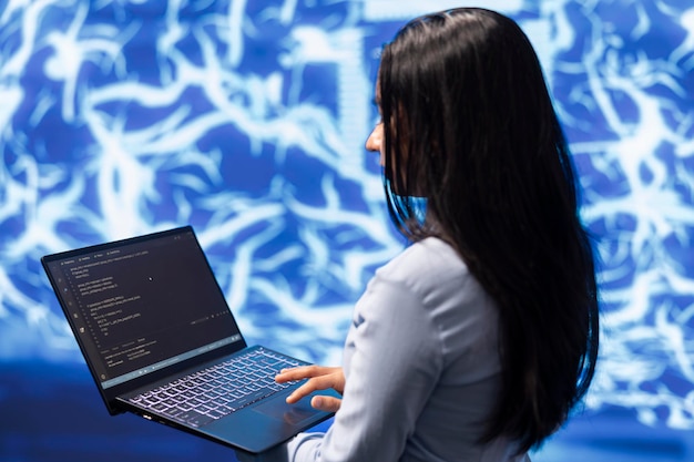 Close up shot of IT expert using AI system and laptop