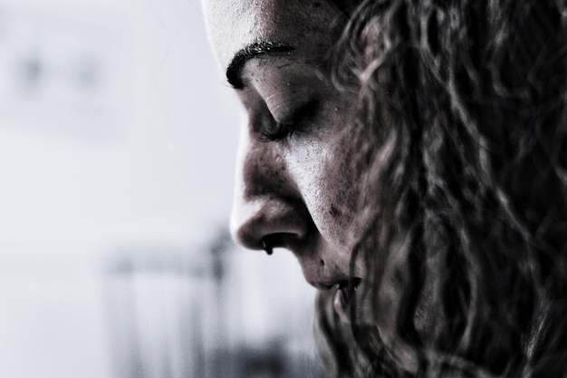 close-up side view of woman with eyes closed at home