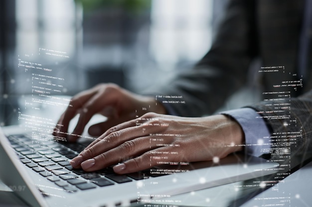 Closeup of male hands using laptop at office