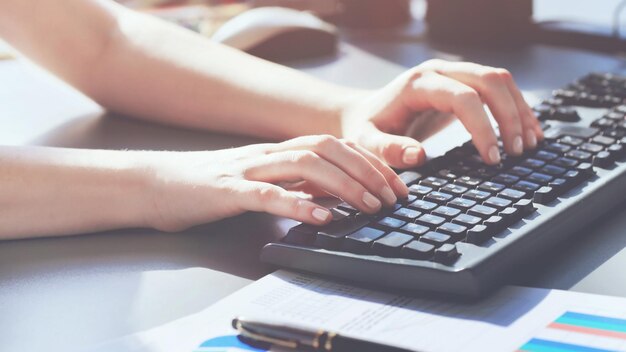 Closeup shot of a female learner typing the keyboard