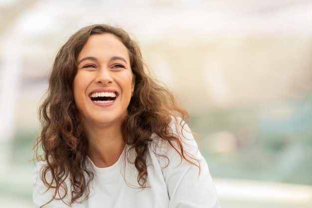 closeup shot of beautiful young woman happily laughing