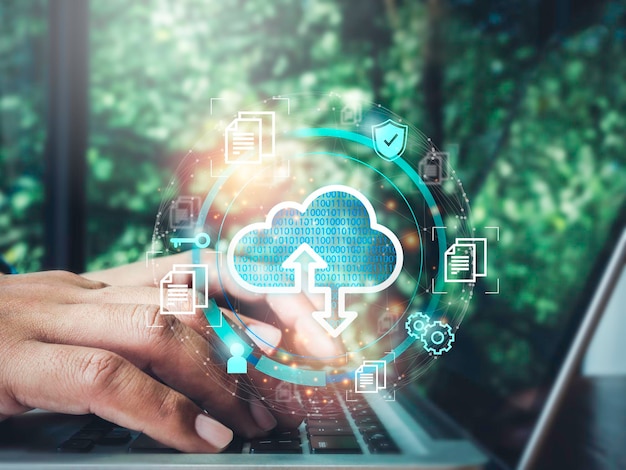 Cloud computing technology concept. Cloud icon virtual with data, security shield, document information symbols appeared while man using a laptop computer. Network data storage technology service.