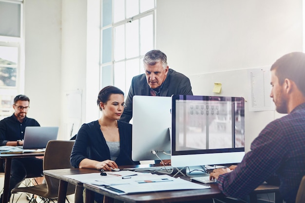 Coaching training and business people with computer in office Leadership teamwork and collaboration of employees woman and mature man on pc working on advertising marketing or sales project