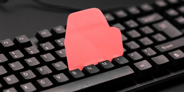 Colored sticker lying on black keyboard Important information written over paper Image with school supplies Multiple Assorted Collection Office Stationery