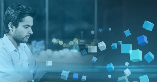 Composition of blue cubes over mixed race businessman in modern office