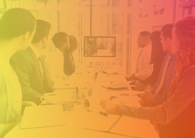 Composition of colorful light over business people during meeting in office