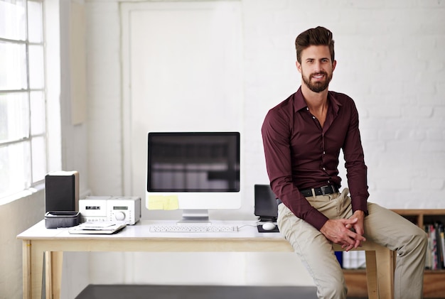 Computer desk and portrait of programmer man in office for administration of creative development Business design and technology with website developer in professional workplace for IT support