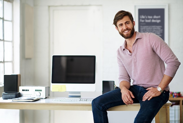 Computer desk and portrait of web design man in office for administration of creative programming Business development and tech with website developer in professional workplace for IT support