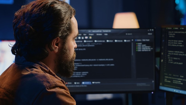 Computer engineer deliberating ways of fixing errors while developing code