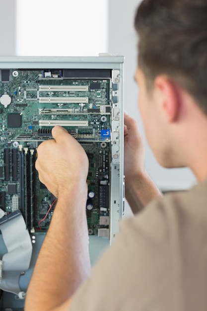 computer engineer repairing open computer
