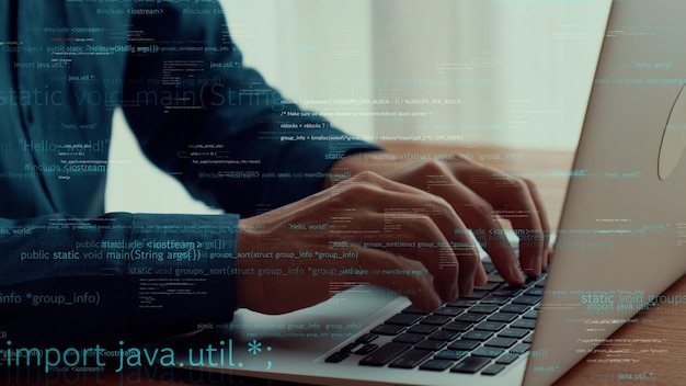 computer programmer uses capable laptop computer to develop programming code