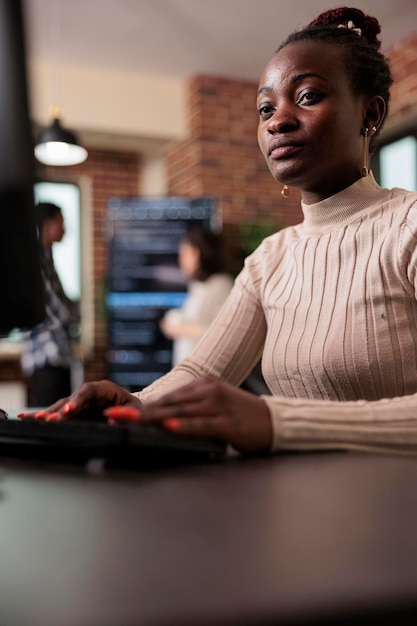 confident african american network developer engineering application for company database. cyber security team member developing advanced firewall system in order to protect encrypted files.