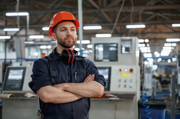 Confident facial expression Factory worker is indoors with hard hat