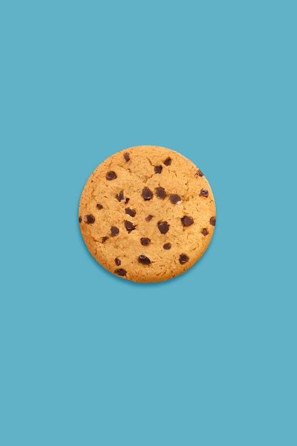 cookie with chocolate chips on light blue background