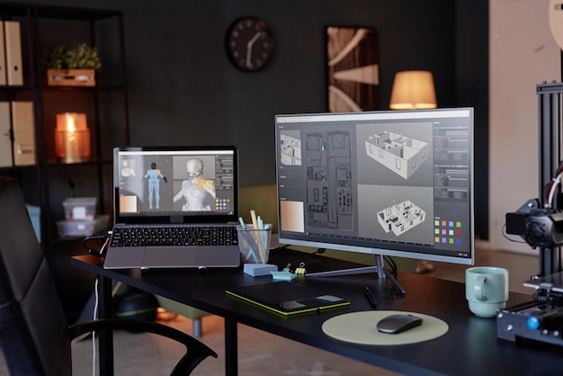 creating digital models on dual computer screens in office