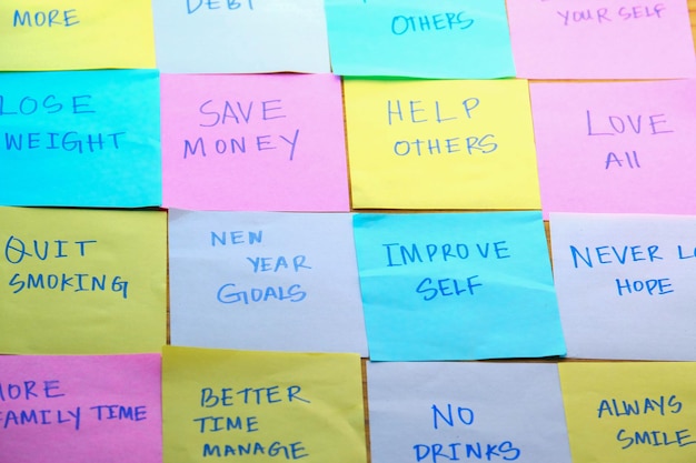 Creating motivational goals and resolutions written on sticky notes for daily inspiration