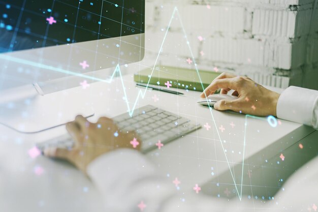 Creative concept of heart pulse illustration and hands typing on laptop on background Medicine and healthcare concept Multiexposure