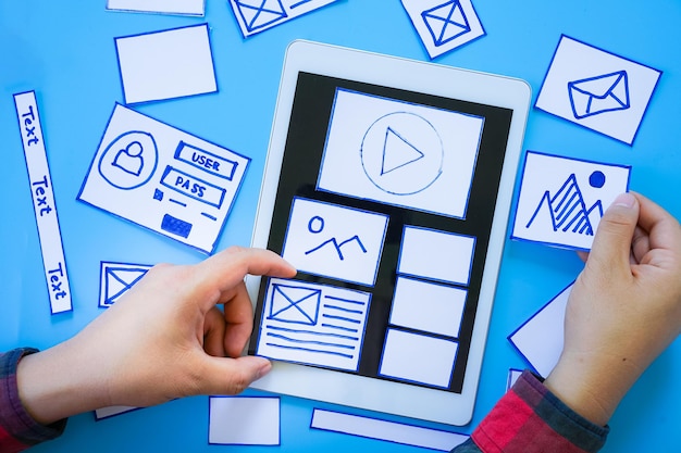 Creative mobile responsive website designer sorting wireframe screens of mobile application process development prototype wireframe User experience concept