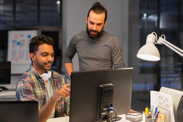 creative team with computer working late at office