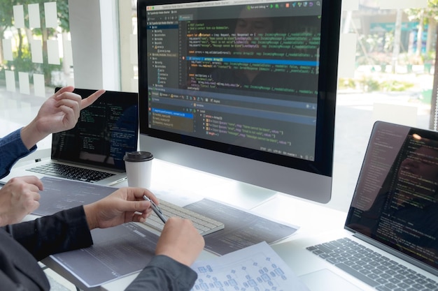 cropped hand of computer programmers brainstorming in office