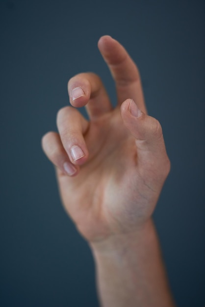 Cropped hand of woman against black background