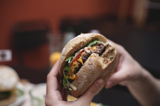 cropped hands having burger