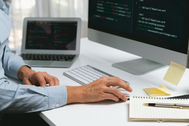 Cropped hands IT developer working online software information on pc Pecuniary