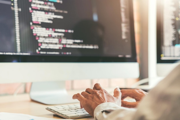 Cropped hands of businessman using computer in office