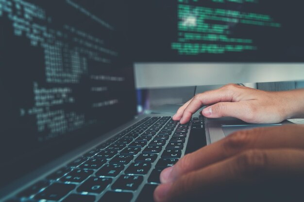 cropped hands of computer programmer using laptop