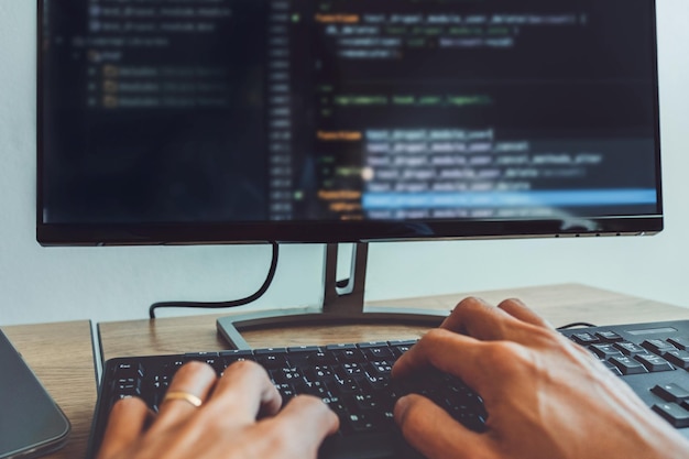 Cropped hands of person using computer