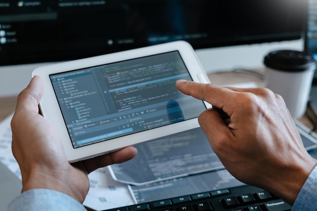 cropped hands of software programmer working on table