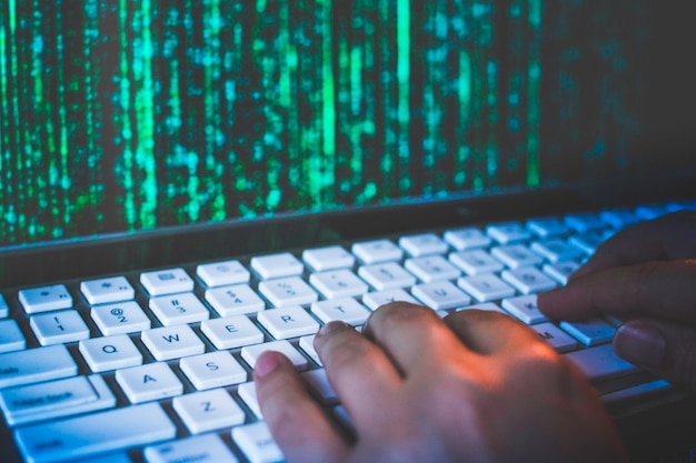 Cropped hands of woman using laptop
