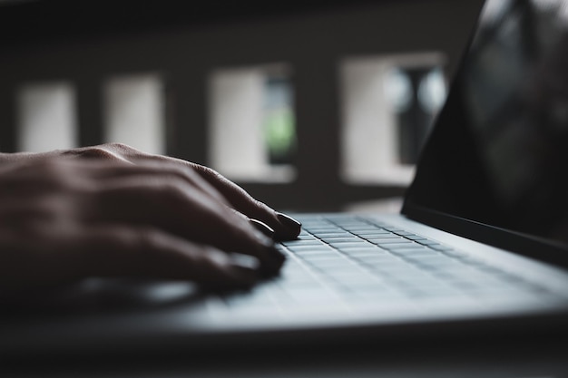 Cropped hands using laptop