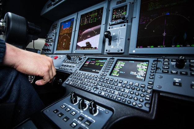 Cropped image of man using laptop at airplane