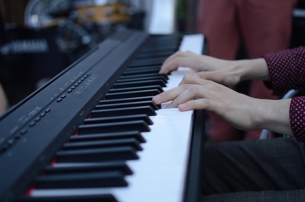 Cropped image of person playing piano