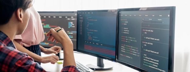 Cropped image of professional programer team collaboration discuss about web coding while coworker point java script displayed on computer at modern company office Closeup Burgeoning