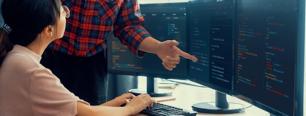 Cropped image of professional programer team collaboration discuss about web coding while coworker point java script displayed on computer at modern company office Closeup Burgeoning