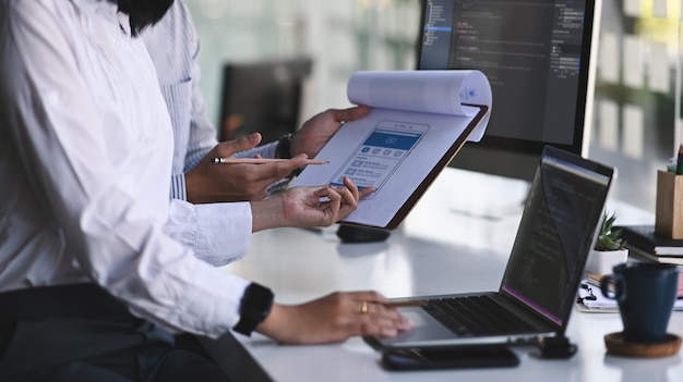 cropped shot of programmer development team working with computer coding.