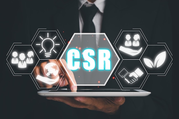 csr corporate social responsibility concept woman using tablet conputer with corporate social responsibility icon on virtual screen