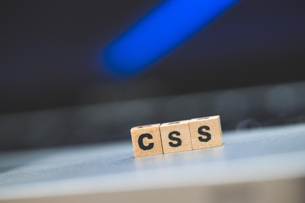 CSS web language Wooden cubes with letters CSS lying on a laptop concept for style sheet language