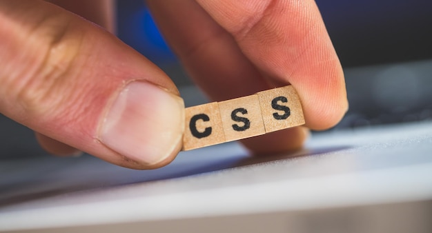 CSS web language Wooden cubes with letters CSS lying on a laptop concept for style sheet language