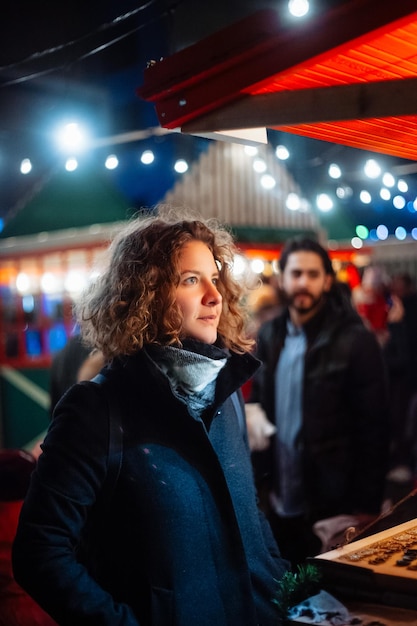curly young woman at night at the fair