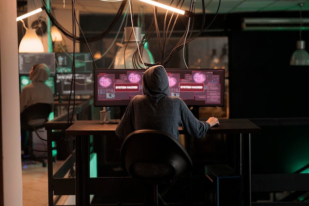 Cyberattack, criminal hacking computer program password, stealing data, sending virus, breaking into database server. Cybercrime, privacy information leak, internet criminal coding spyware, back view