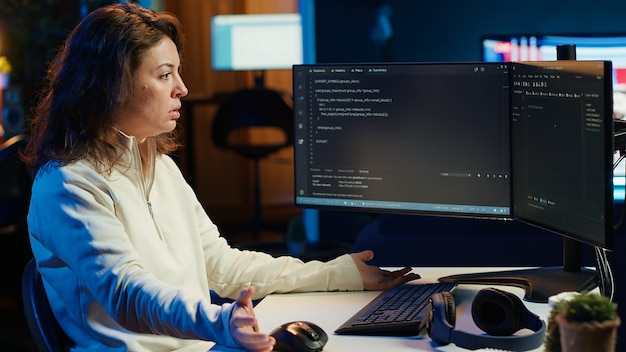 cybersecurity expert looking confused at code on computer screen