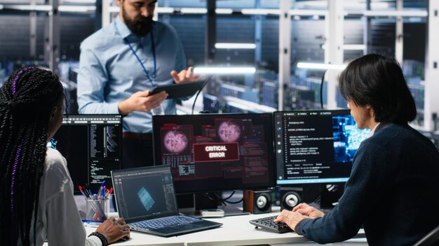 Data center manager coordinating programmers fixing critical error while using ai server room team