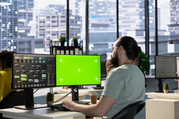 Data scientist using green screen pc to create machine learning models that can process data to
