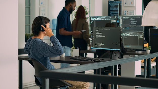 Database programer writing source code and developing security server with html script on computer. App developer typing on keyboard to create software program, computing big data.