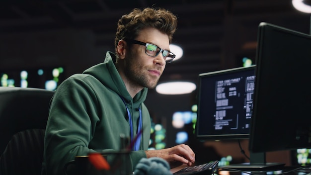Datacenter analyst looking monitors in advanced monitoring office closeup