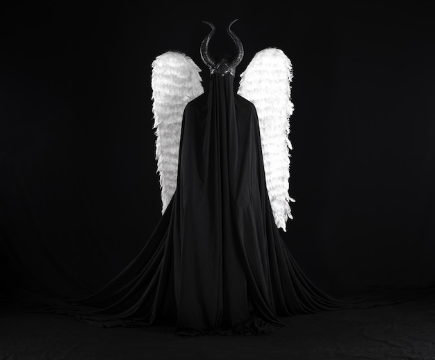demon angel with white wings on a black background