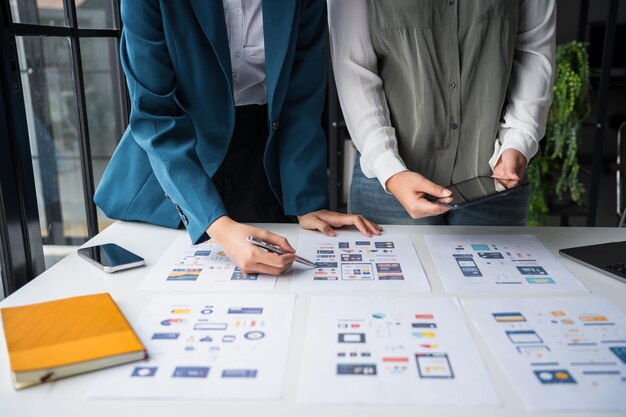 Developer team brainstorming user interface and experience designs for mobile application ux ui graphic prototype
